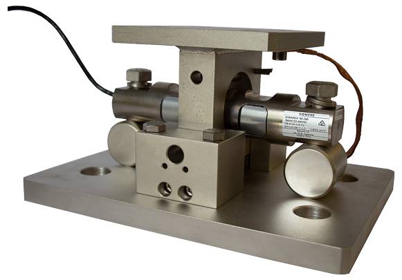 Ein Metallapparat mit zylindrischen Komponenten, die auf einer rechteckigen Basis montiert sind, vermutlich für industrielle Messung oder Gewichtskalibrierung verwendet.