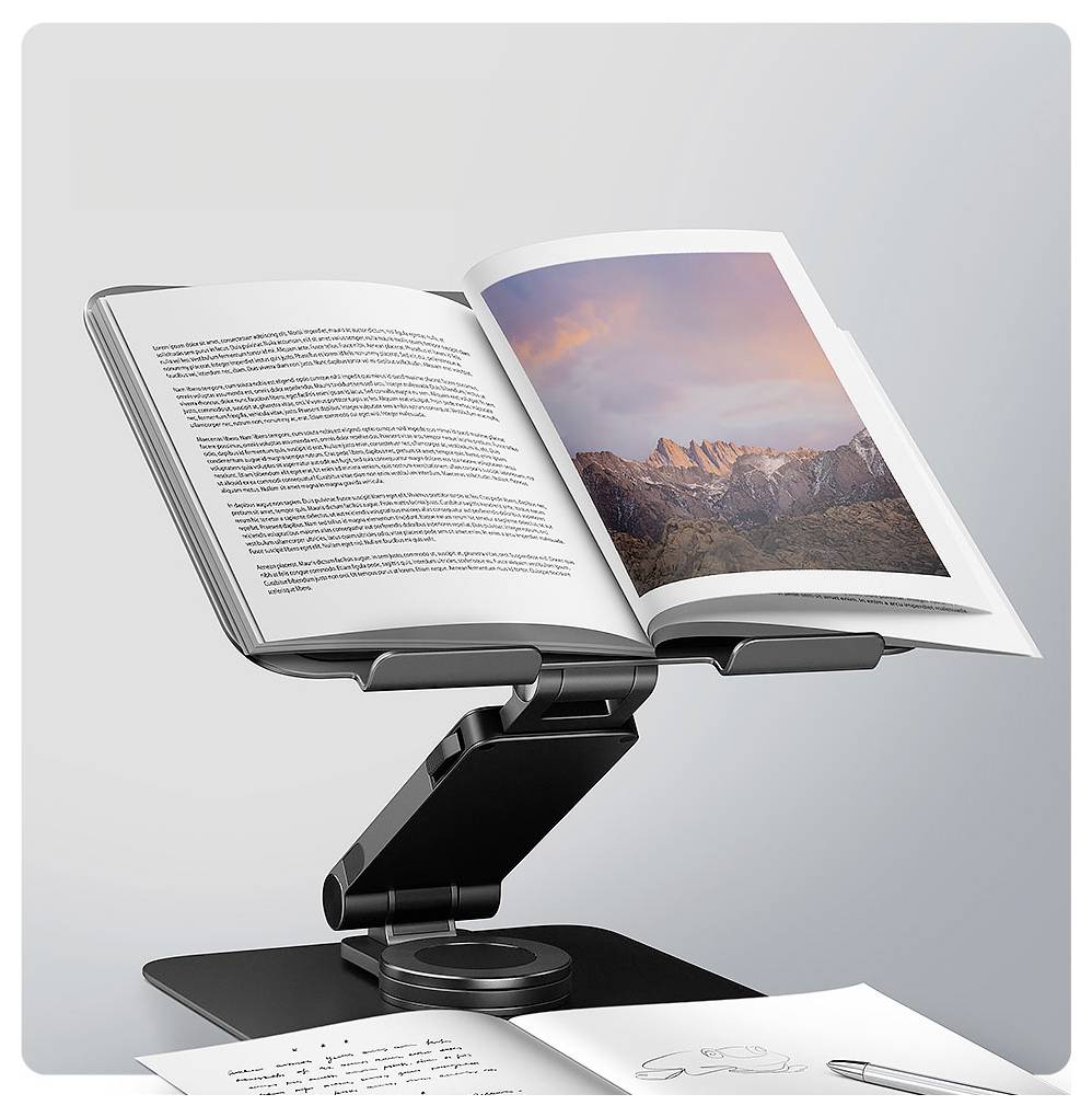 Ein ergonomisches Buchständer hält ein aufgeschlagenes Buch, das ein Landschaftsfoto zeigt. Seiten eines anderen Dokuments liegen auf dem Tisch darunter.