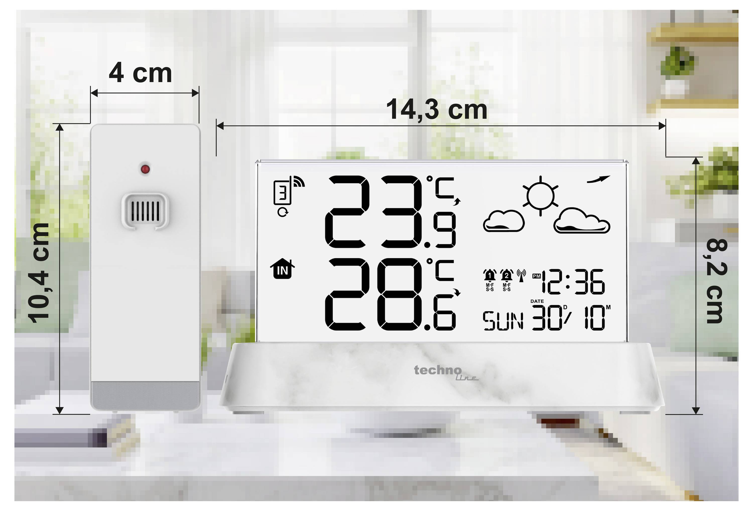 White digital thermometer-hygrometer display on a stand shows 23.9°C and 28.6°C, with weather icons, time 12:36, and date SUN 30/10; size measurements are labeled around it.