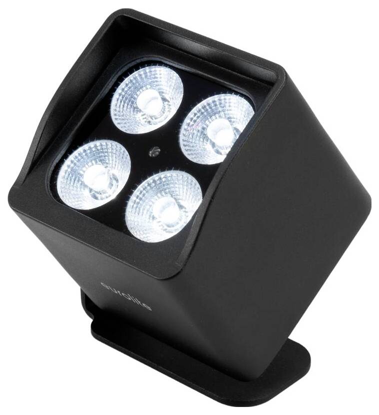Ein schwarzer, würfelförmiger LED-Strahler mit vier hellen, runden Lichtern im Inneren, nach oben angewinkelt, auf einem kleinen Sockel.