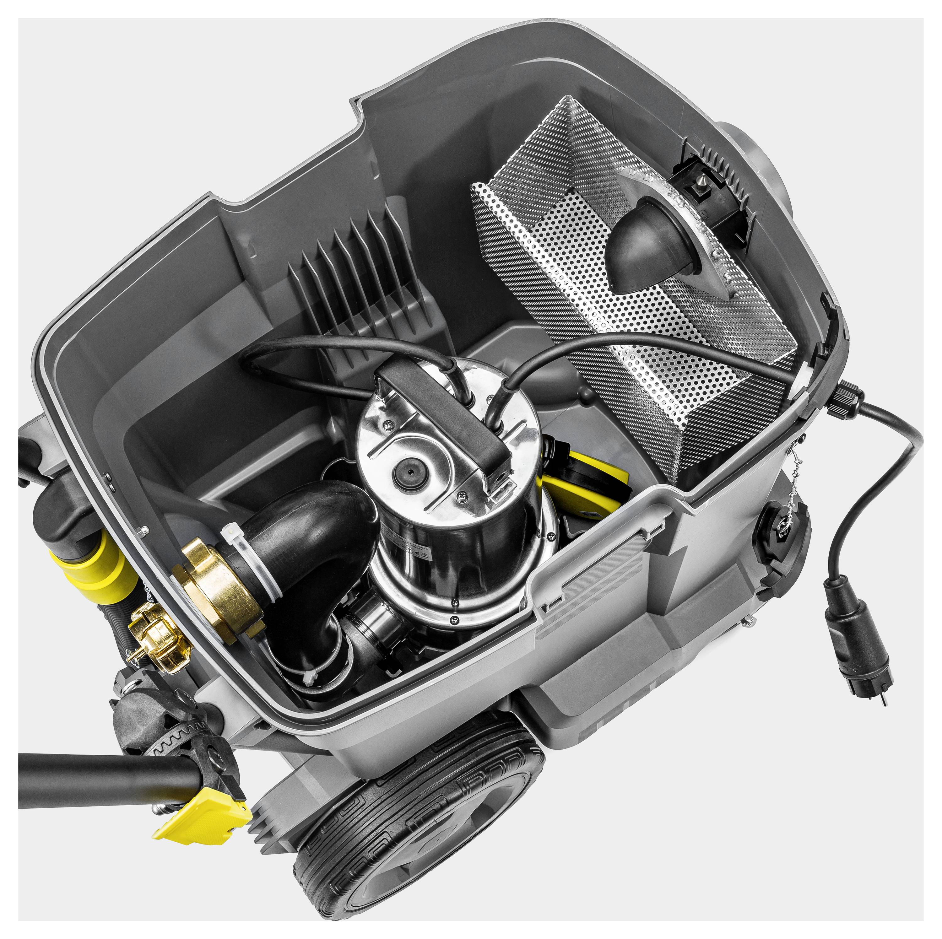 Das Bild zeigt einen offenen, tragbaren Industriestaubsauger mit sichtbaren Komponenten, einschließlich eines Motors, Schlauchaufsätze und eines Filterkorbs.