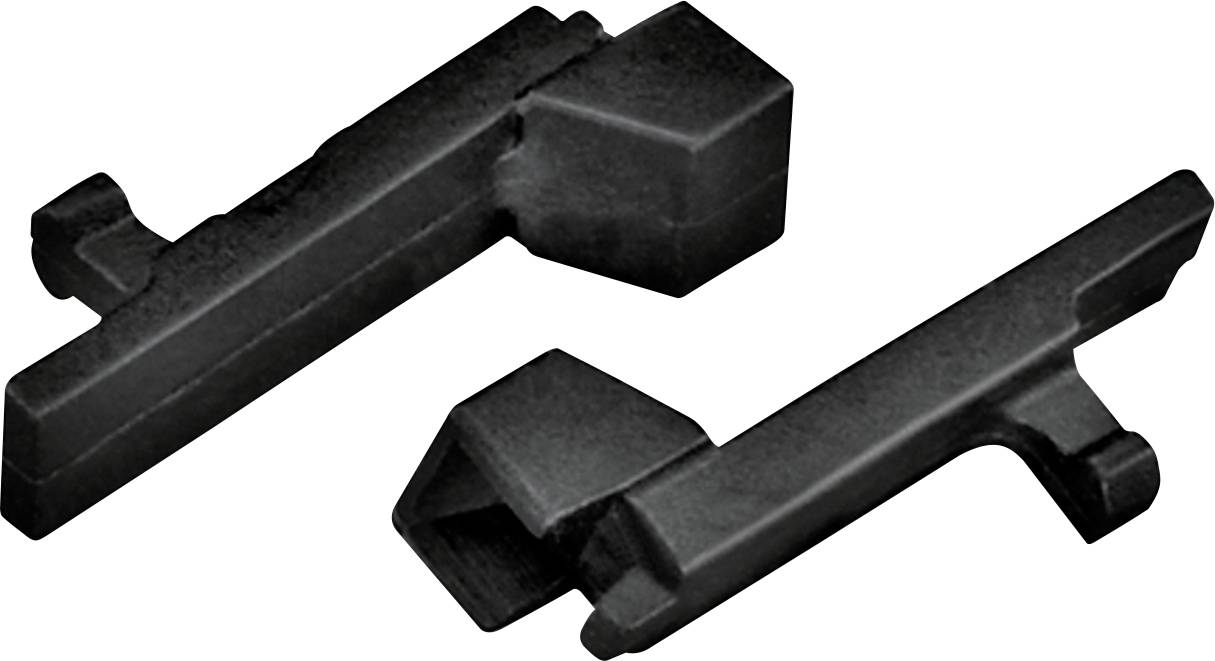 Zwei schwarze Metallobjekte mit eckigen Formen und Vorsprüngen, möglicherweise Werkzeuge oder Komponenten, liegen auf einer weißen Oberfläche.