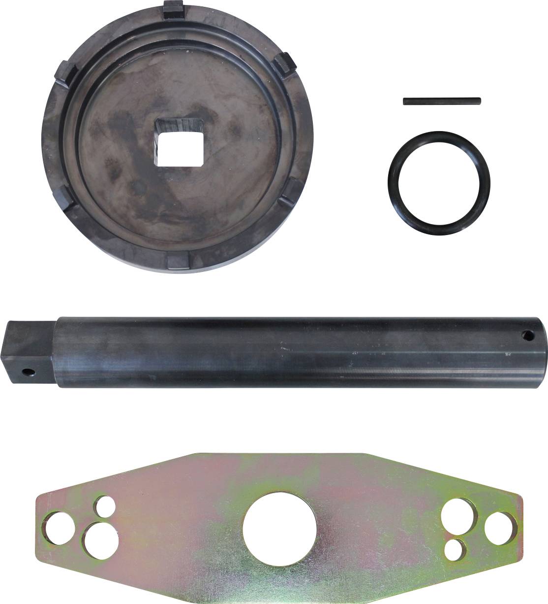 Ein Bremsschuh-Werkzeugsatz mit einer Kreisplatte, Zylinderstange, Ring, Stift und einer flachen Metallhalterung mit Löchern, der für Kfz-Reparaturen verwendet wird.