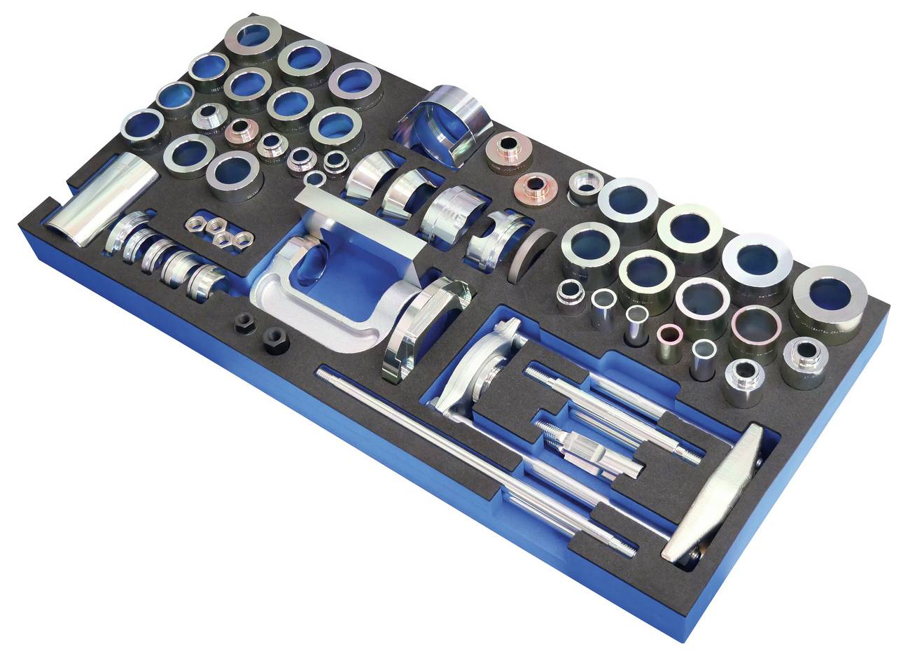 Verschiedene Präzisions-Metallringe, Zylinder und Stäbe, die in einem Schaumstofftablett angeordnet sind, wahrscheinlich Teil eines spezialisierten Werkzeugs oder Kalibriersets.