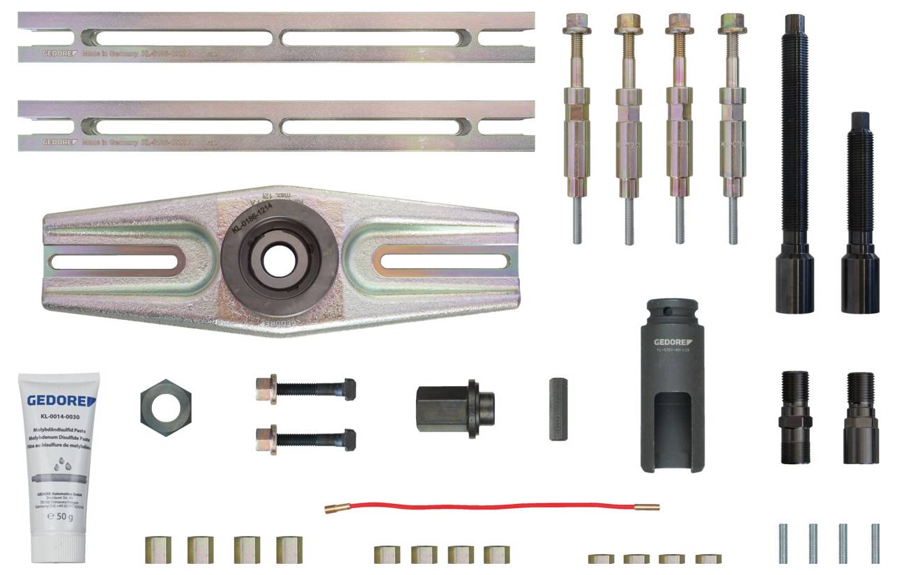 Ein umfassendes Werkzeugsortiment, bestehend aus Metallstangen, Schraubendrehern, einem Lagerpuller, weiteren Komponenten und einer Fettpresse für mechanische Arbeiten.