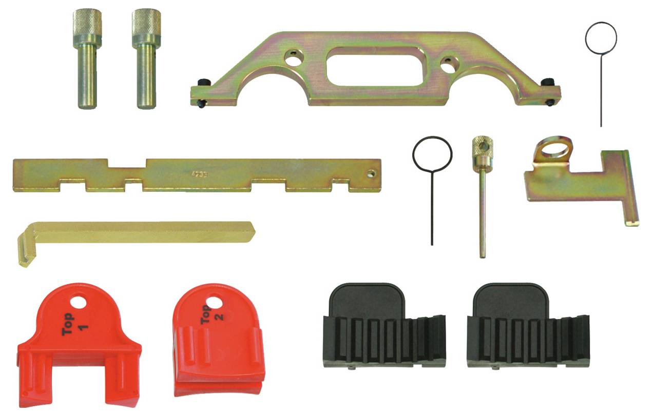 Sortierter Sortiment aus Metall- und Kunststoff-Automotivauxiliarwerkzeugen für Motorzeitsteuerung, einschließlich Ausrichtungshalterungen, Verriegelungsstifte und Führungen, auf einer Oberfläche angeordnet.