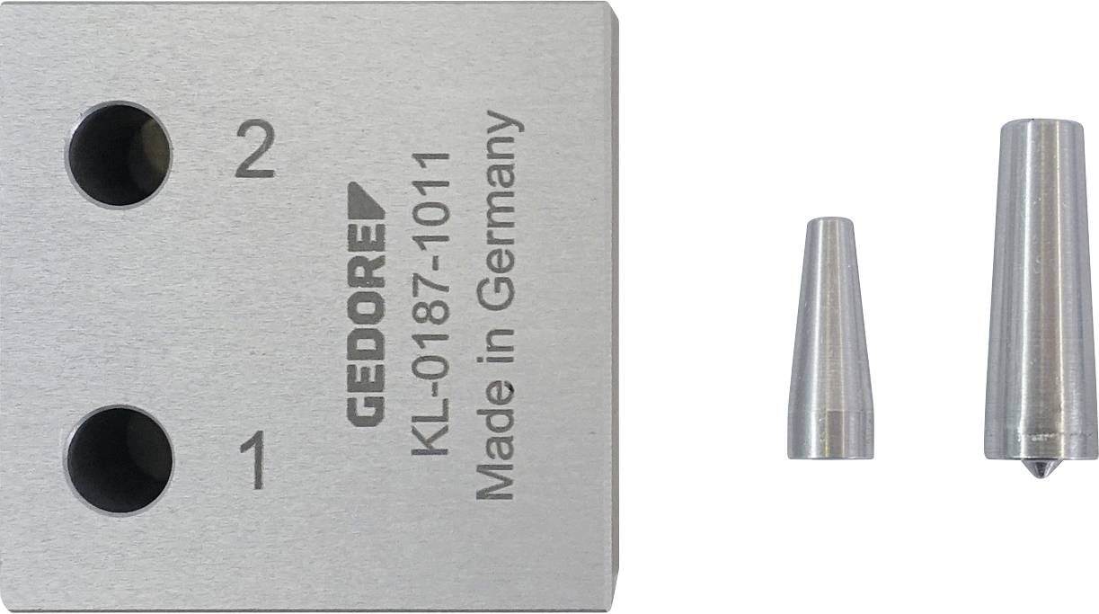 Metallblock mit zwei Löchern mit den Beschriftungen 