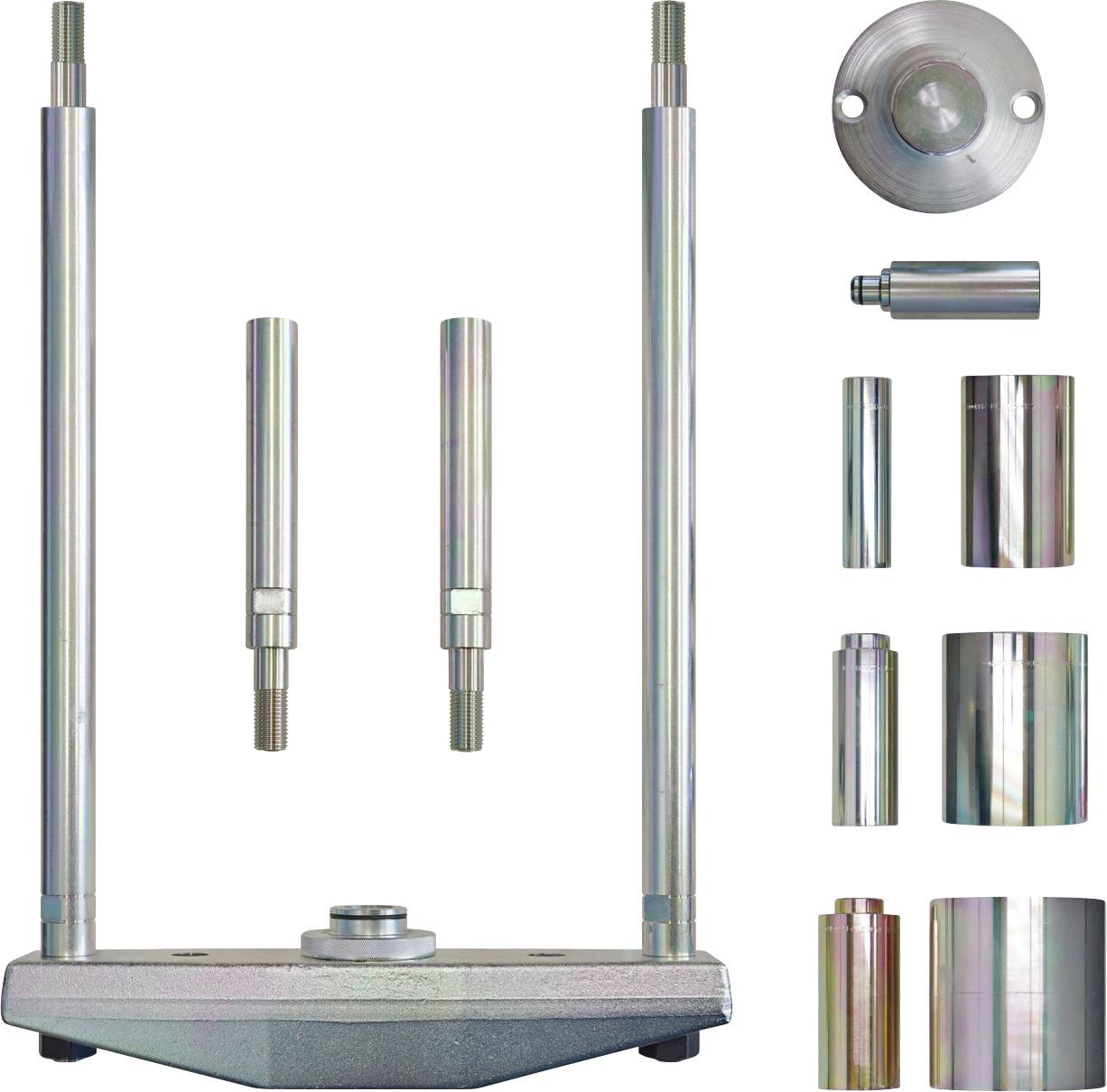 Ein Satz Automobilwerkzeuge einschließlich verschiedener zylindrischer Metallkomponenten mit Gewinde an den Enden, angeordnet neben einer Grundplatte.