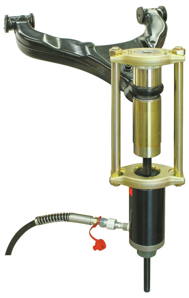 Eine Werkzeugmaschine mit einer zylindrischen Hydraulikpresse, verbunden durch Metallstreben, die zur Wartung von Fahrzeugsuspensionsbauteilen verwendet wird.