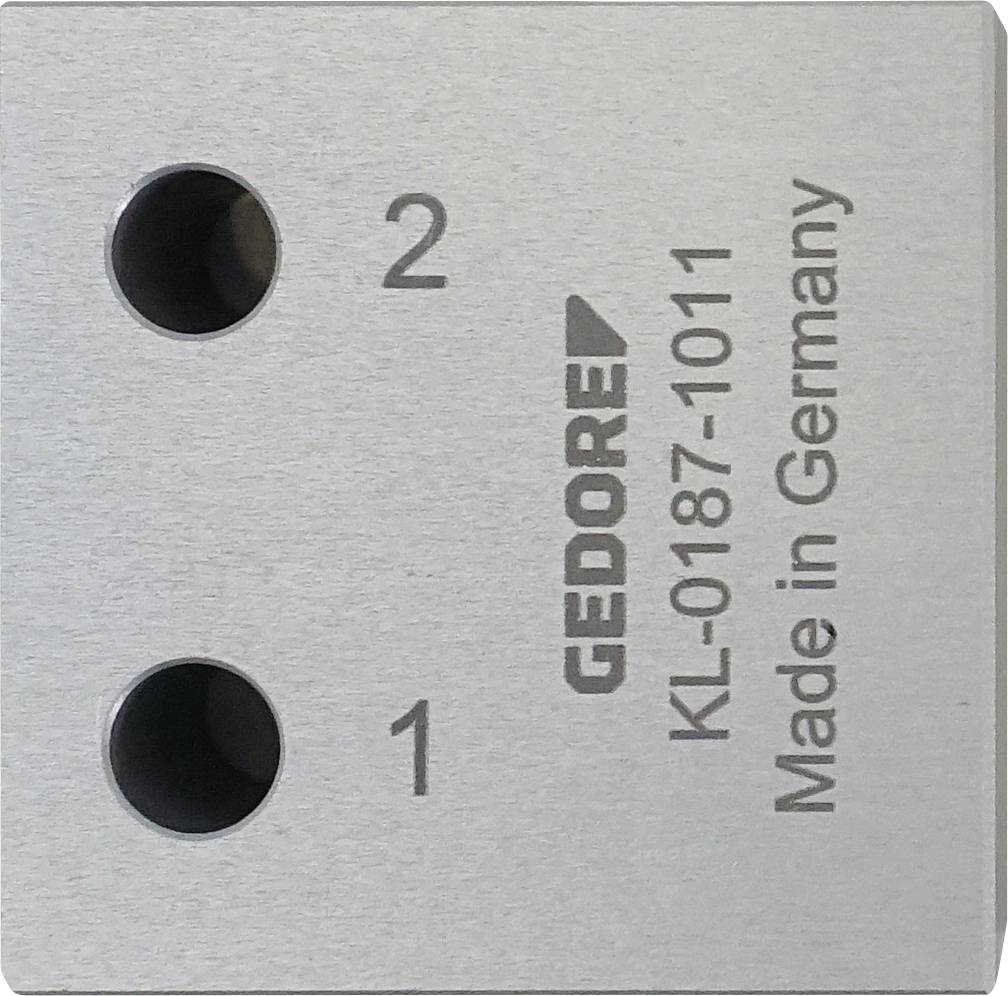 Ein offenes schwarzes Gehäuse mit sechseckigem Muster und blauen Akzenten, das vier zylindrische metallische Objekte enthält, die sicher in Schaumstoff eingepasst sind.