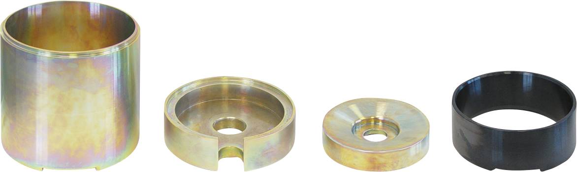 „Vier metallische Werkzeugkomponenten in verschiedenen Formen und Größen, von links nach rechts angeordnet, zeigen einen zylindrischen Becher, einen geschlitzten Ring, eine flache Scheibe und einen schwarzen Ring.