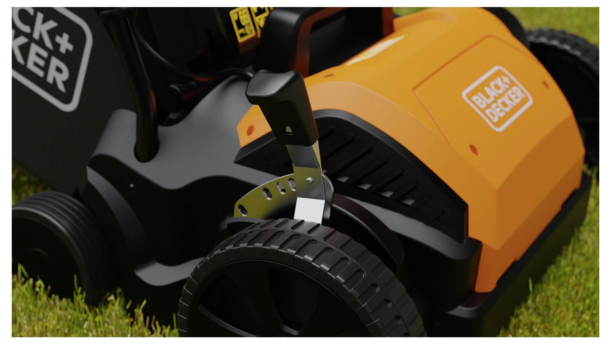 Ein orange-schwarzer Rasenmäher ist auf Gras geparkt und verfügt über einen Hebel am Rad sowie das 