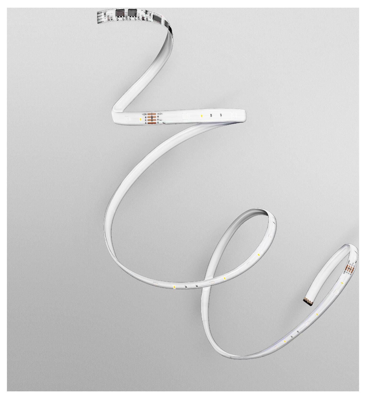 Ein LED-Streifenlicht windet sich spiralförmig vor einem grauen Hintergrund und demonstriert dabei seine Flexibilität und kleine beleuchtete Abschnitte.