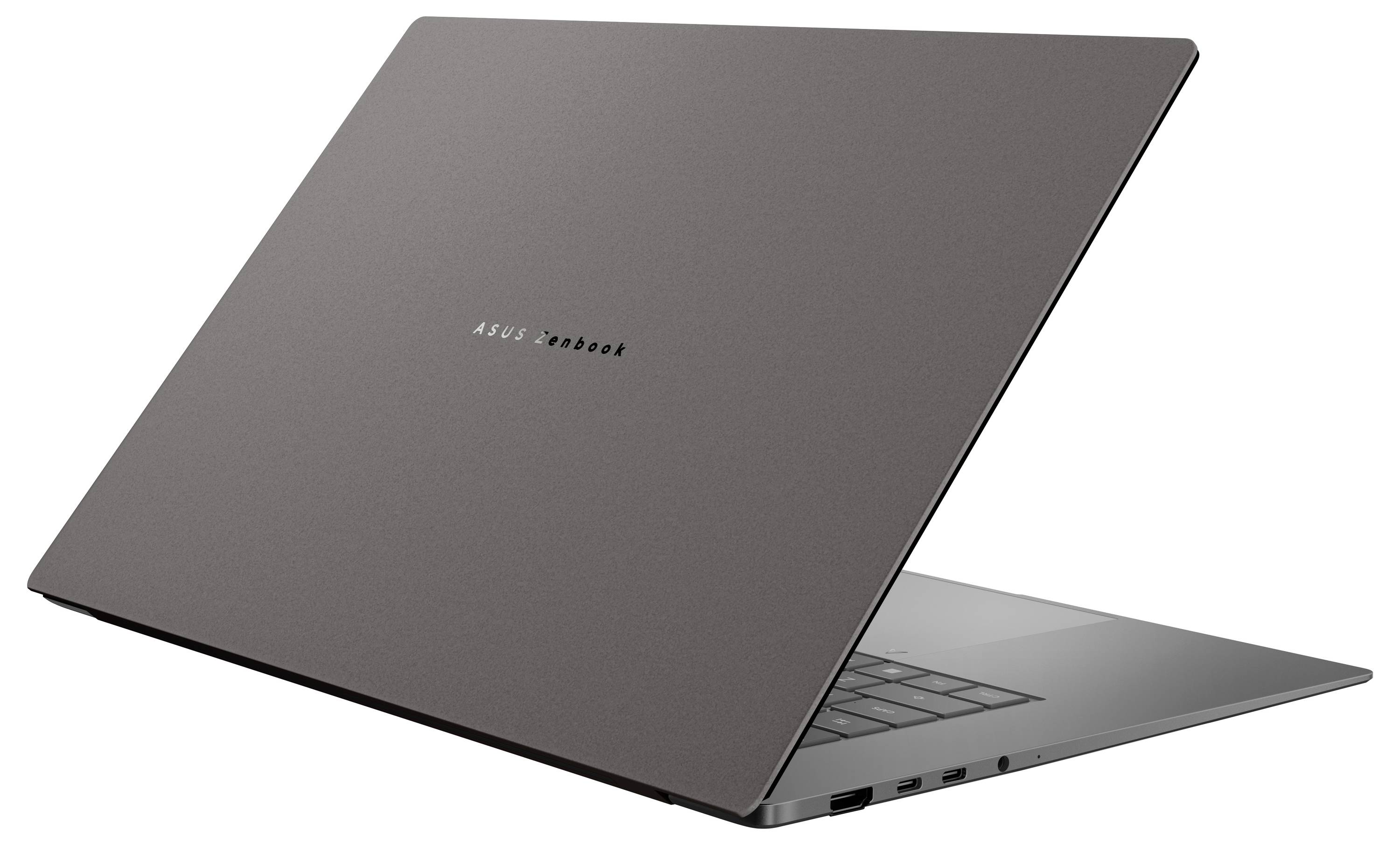 Ein eleganter, dünner Laptop mit teilweise geöffnetem Deckel, der die Tastatur zeigt. Das Design ist minimalistisch mit einer dunklen Metallic-Oberfläche.