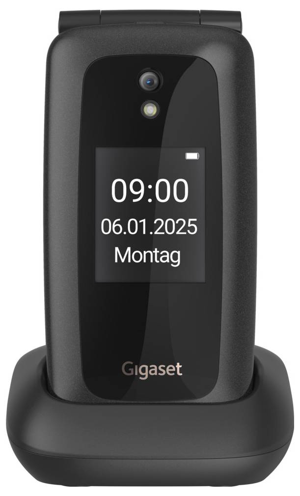 Ein schwarzes Klapphandy auf einer Ladestation zeigt auf dem Bildschirm 