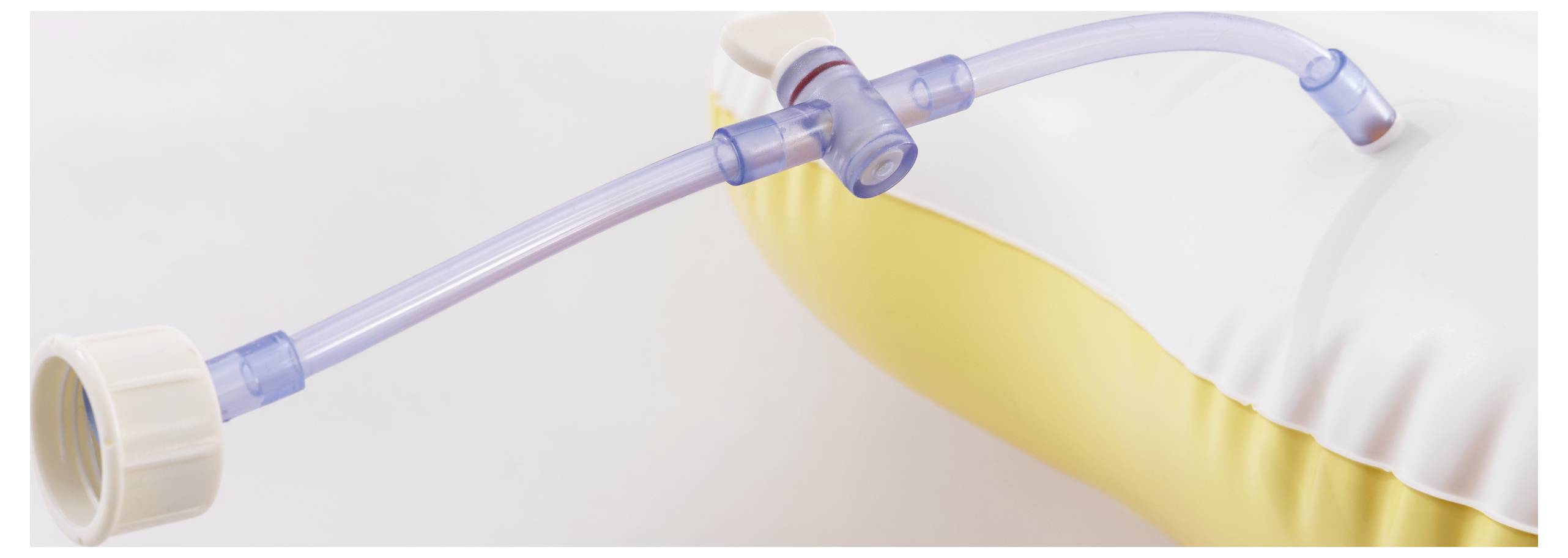 Tubing connector attached to an inflatable medical cushion, displaying parts for air inflation and deflation.
