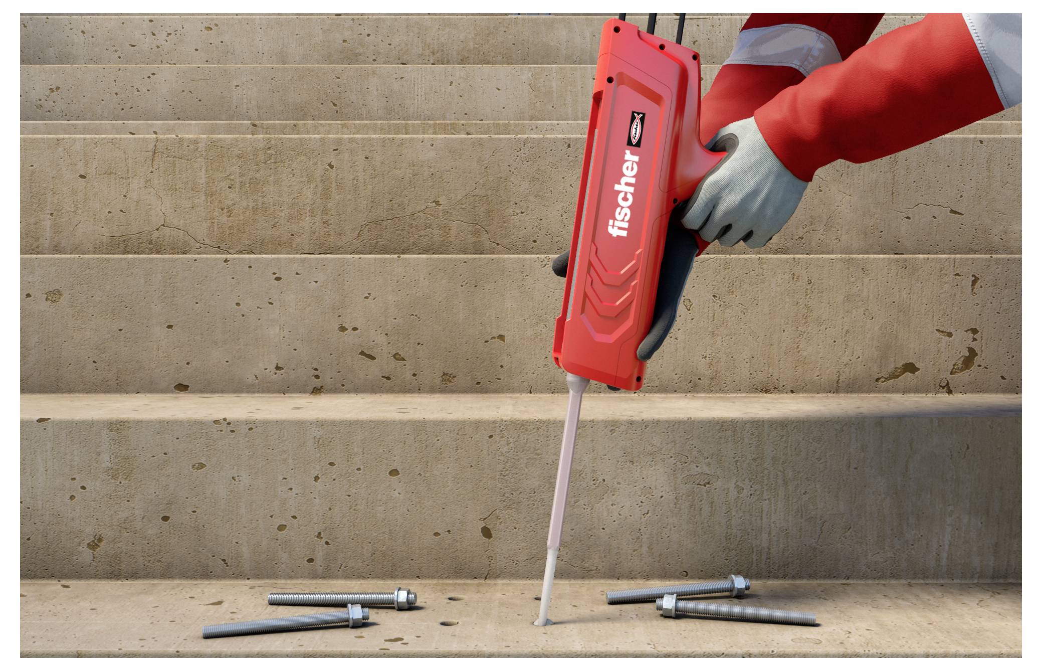 Eine Person verwendet ein rotes Fischer-Werkzeug, um Material auf eine Betonstufe zu injizieren, umgeben von Bolzen, für eine Baustoffaufgabe.
