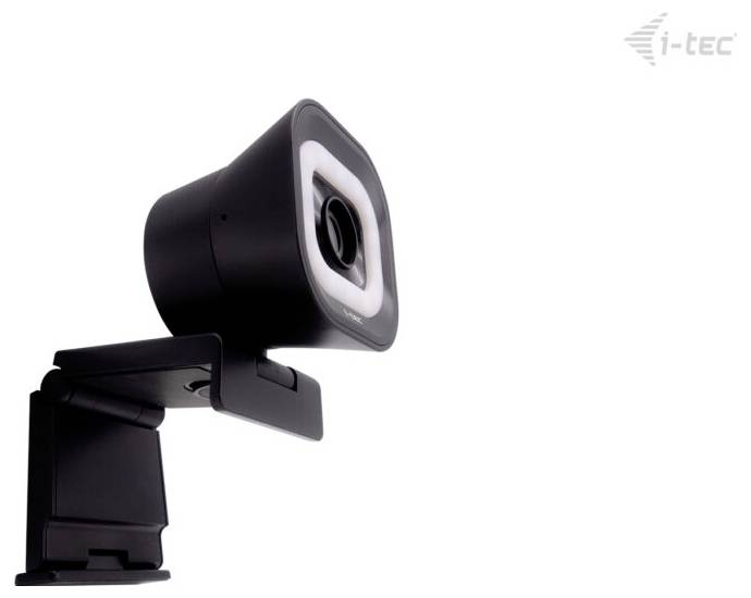 Eine schwarze Webcam mit integriertem Ringlicht, montiert auf einem verstellbaren Stativ vor einem einfachen weißen Hintergrund. Das Markenlogo befindet sich in der oberen rechten Ecke.