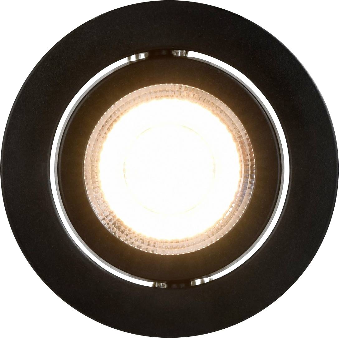 Ein kreisförmiges LED-Licht von unten gesehen, das einen hellen weißen Glanz ausstrahlt, eingebettet in ein dunkles kreisförmiges Gehäuse.