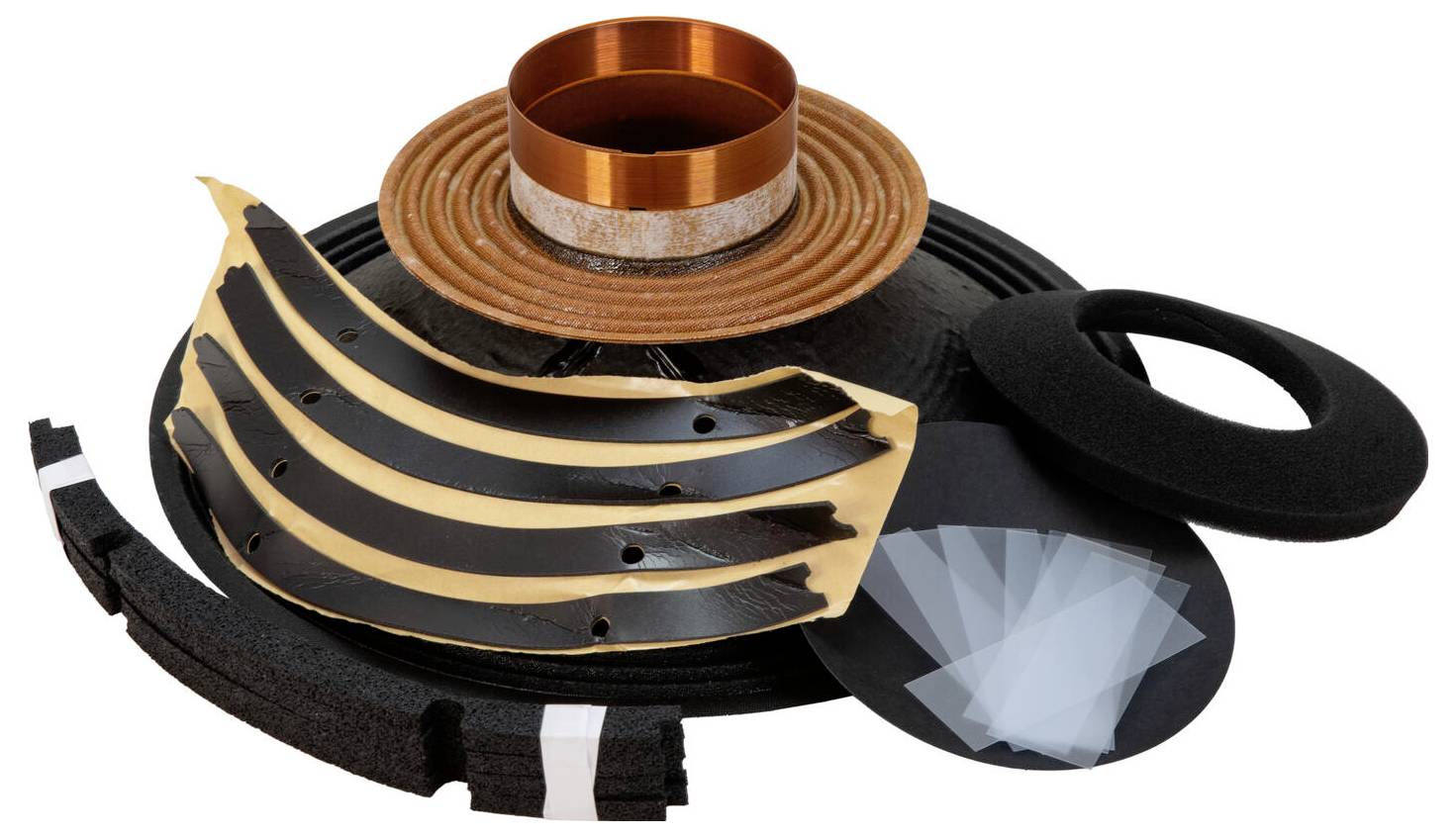 Teile eines Lautsprechers, einschließlich Membran, Spule, Aufhängungssystem und Dichtungen, angeordnet und auf weißem Hintergrund präsentiert.