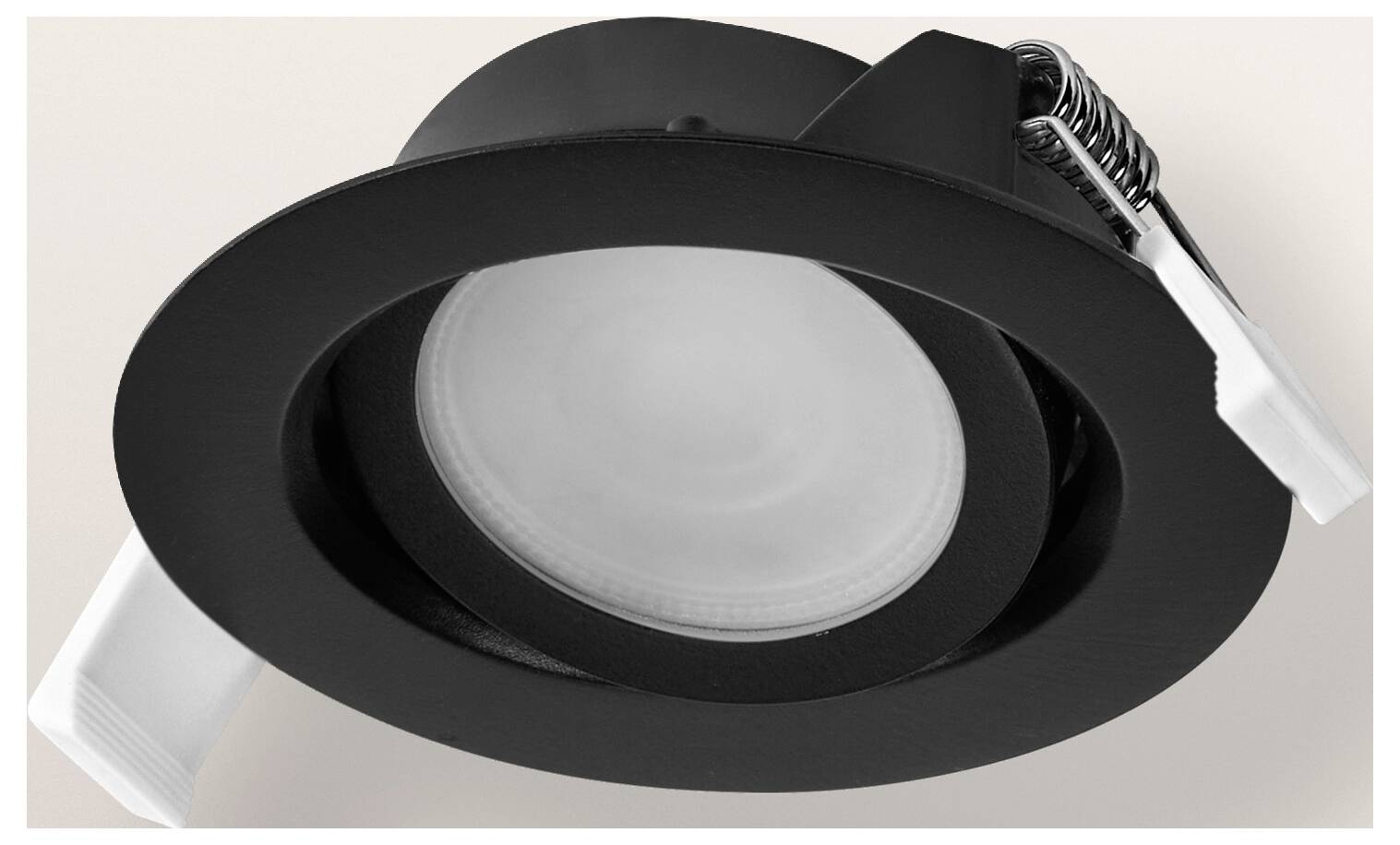 Eine schwarze, bündig in der Decke eingelassene LED-Deckenleuchte mit kreisförmigem Design, montiert in einer weißen Decke, mit modernem, minimalistische Stil.