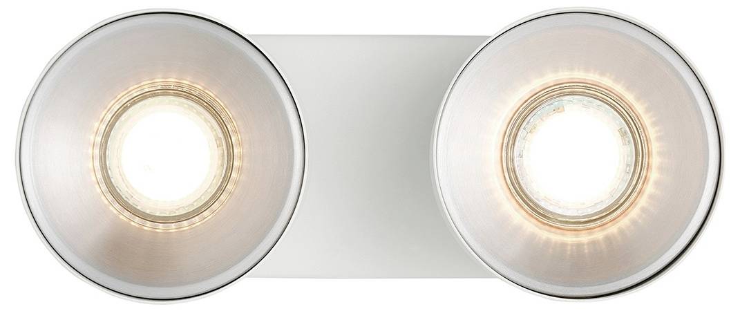 Aufsicht auf zwei kreisförmige, metallische Leuchten, die auf einer rechteckigen Basis montiert sind, mit hellen Glühbirnen, die von den Zentren aus leuchten.