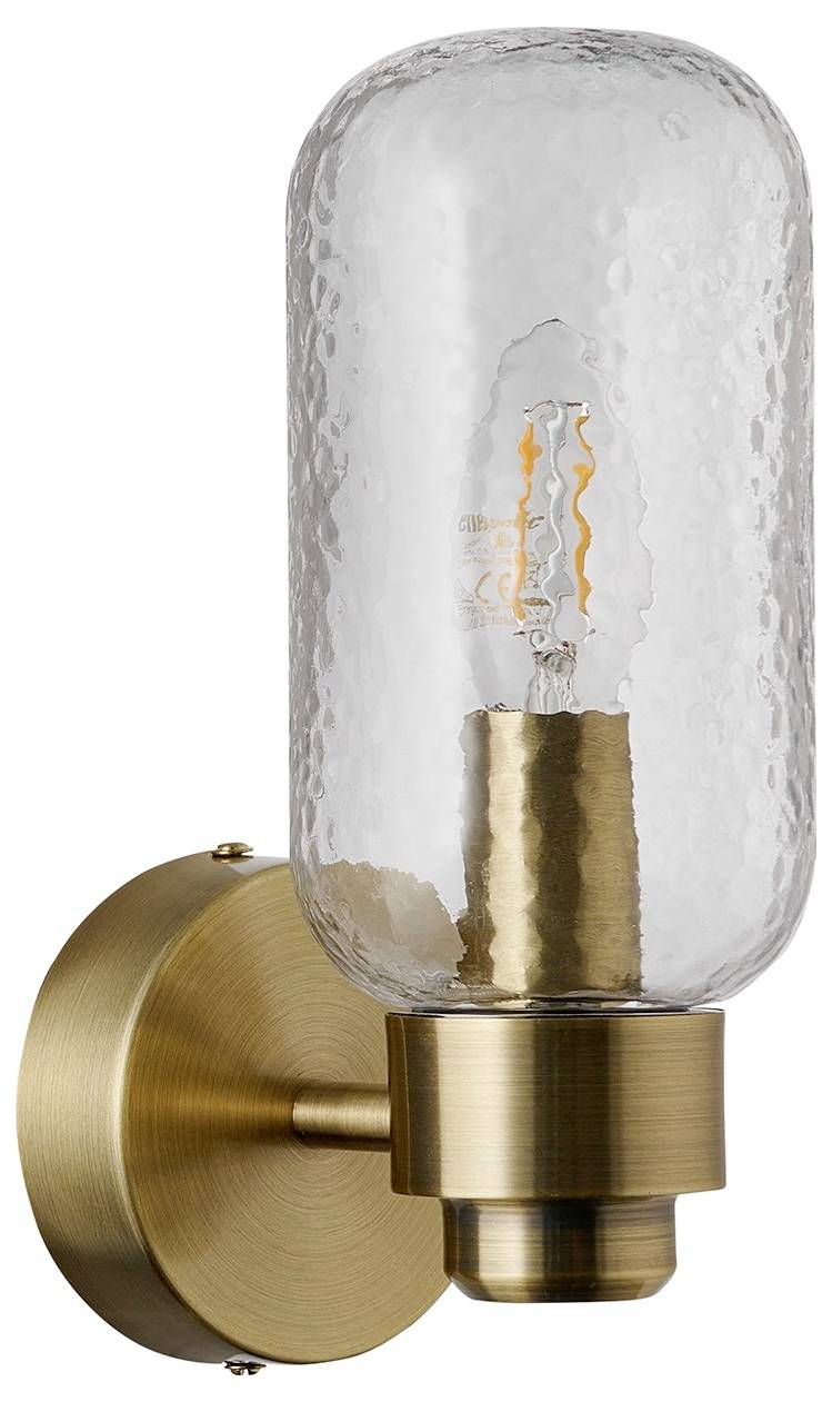 Eine bronzefarbene Wandleuchte mit zylindrischem, strukturiertem Glasschiber offenbart eine sichtbare Glühfadenlampe und kombiniert damit moderne und vintage Designelemente.
