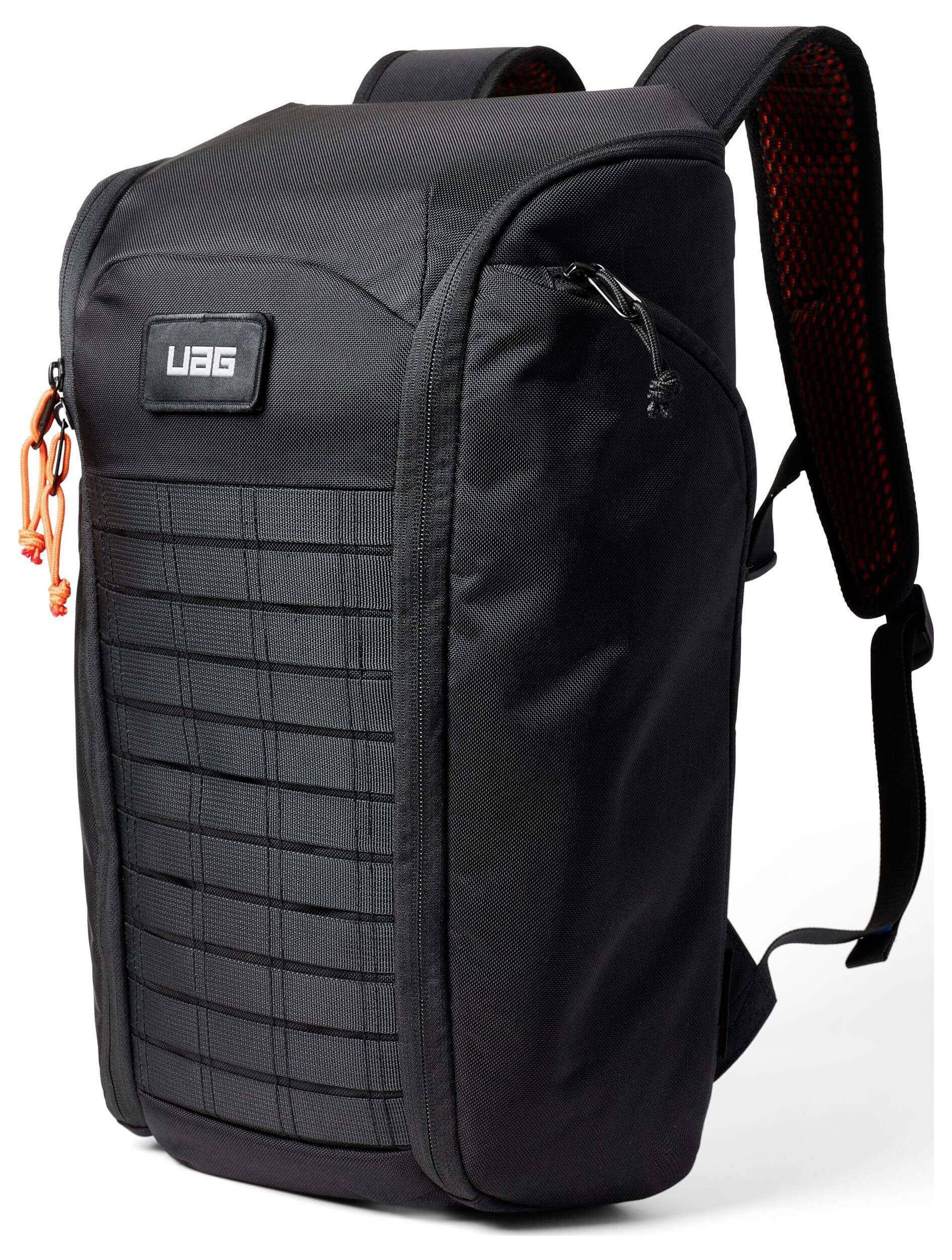 „Ein schwarzer UAG-Rucksack mit gepolsterten Trägern und einem orangefarbenen Reißverschluss-Anhänger, entwickelt für robustes Tragen, mit einem Rastermuster auf der Vorderseite.