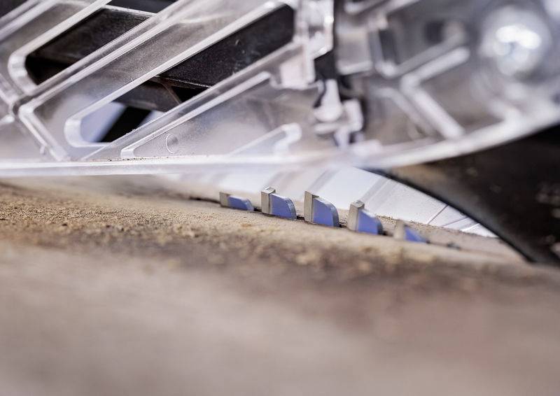 Eine Nahaufnahme einer Kreissägeblatt, das durch ein Holzbrett schneidet. Das metallische Blatt und die Sägespäne sind sichtbar und betonen die Aktion.