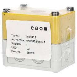 Ein gelbes und graues elektronisches Gerät mit Etikettendetails: 'eao, Typ-Nr. 704.945.8, Art.-Nr./Vers. 0704945.8/Vers. A, Stückzahl 1, 320211, Ident.-Nr. 259288'.