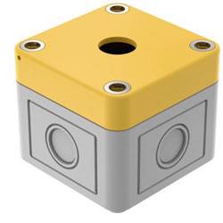 Eine kleine, quadratische, gelb-grau Elektroverteilerdose mit kreisförmigen Akzenten an den Seiten und Schraubenlöchern in den Ecken.