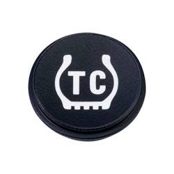 Eine schwarze runde Schaltfläche mit einem weißen Symbol, das einer Reifenprofilierung ähnelt, und den Buchstaben „TC