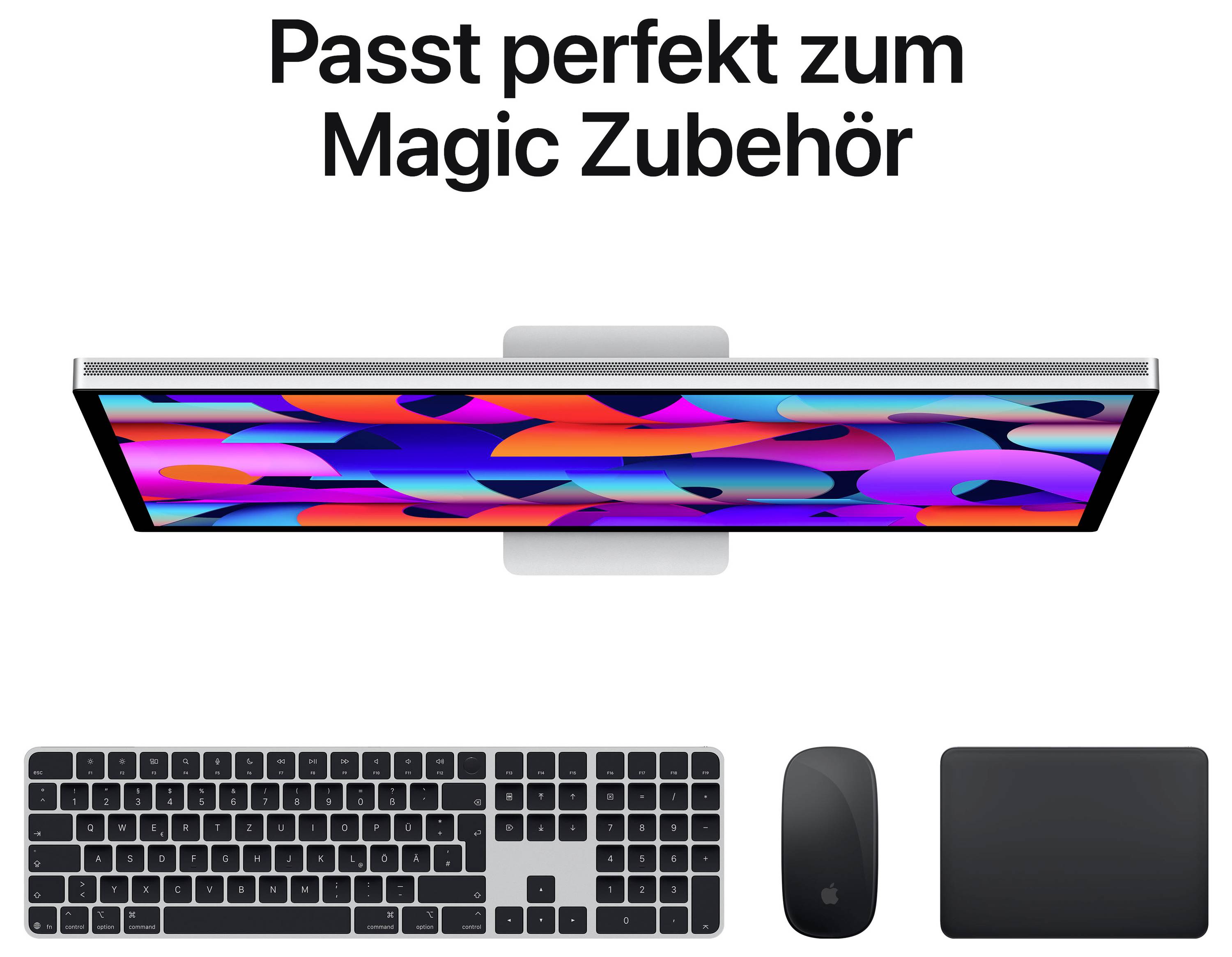 Ein Bildschirm mit buntem Muster zeigt 'Passt perfekt zum Magic Zubehör', darunter eine Tastatur, Maus und Trackpad in Schwarz.