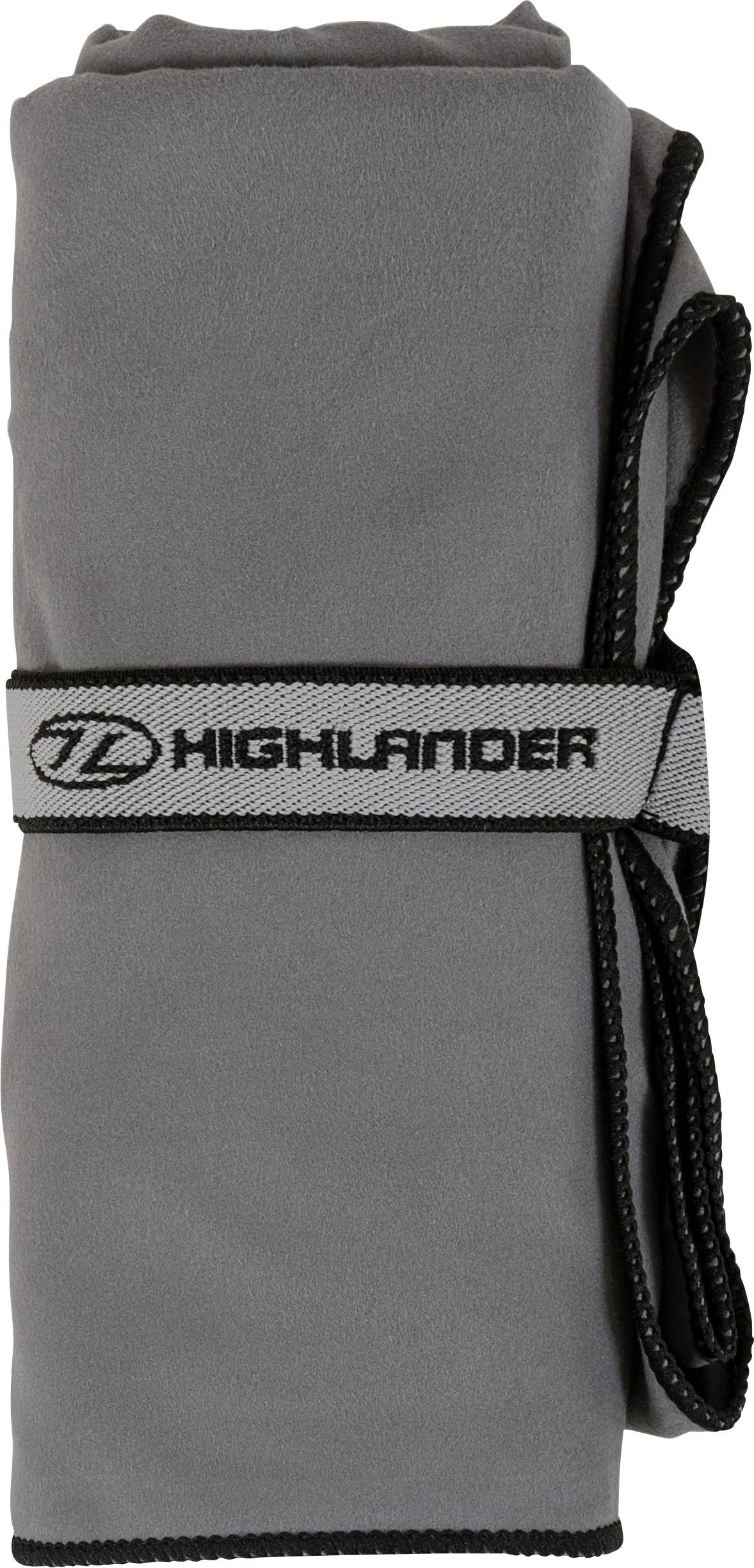 Ein grau aufgerolltes Mikrofasertuch, das mit einem schwarzen Gummiband gesichert ist, das mit „Highlander