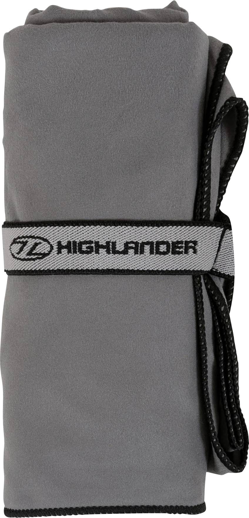 Ein grau zusammengerolltes Microfaser-Handtuch, gesichert mit einem Riemen, der das „Highlander