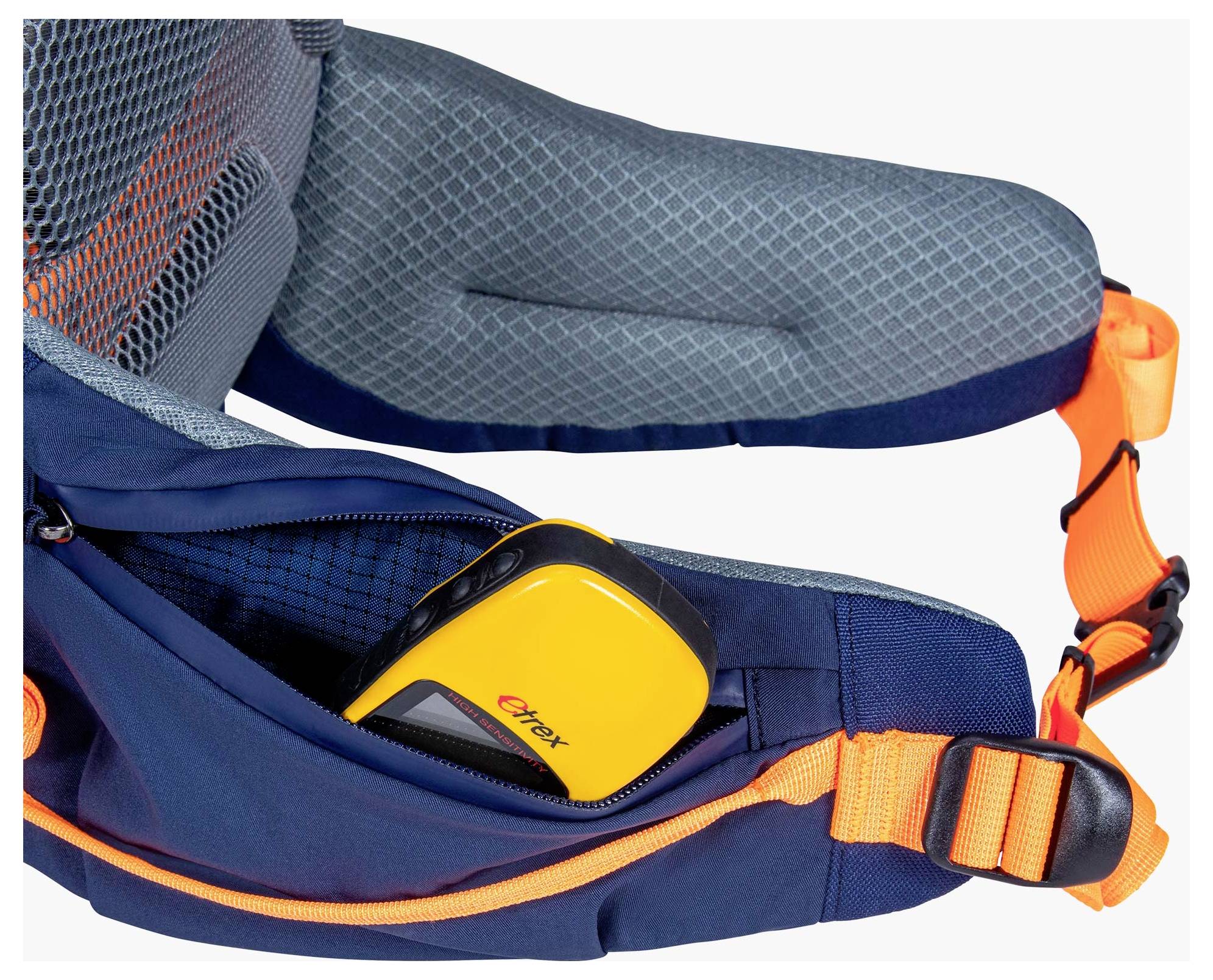 Ein Nahaufnahme eines orange-schwarzen GPS-Geräts, das teilweise in der offenen Tasche eines blauen Rucksacks mit orangefarbenen Riemen sichtbar ist.