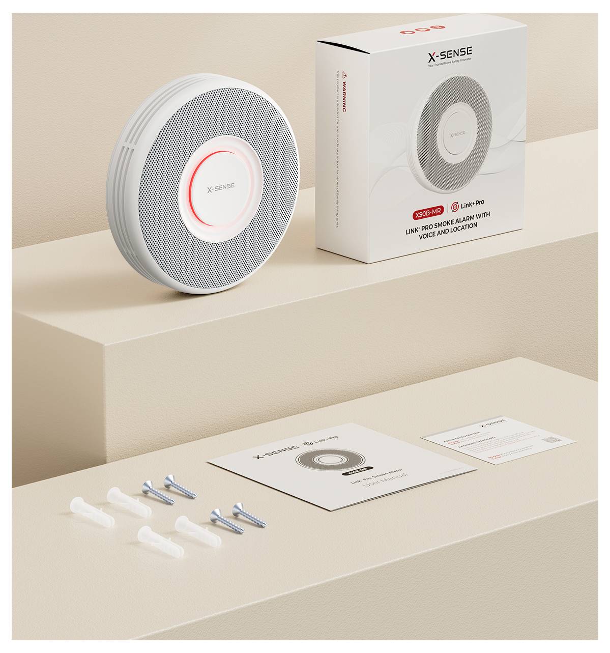 Ein Rauchmelder und seine Verpackung werden gezeigt. Enthalten sind Installationszubehör, eine Bedienungsanleitung und eine Schnellstartanleitung auf einer beigen Oberfläche.