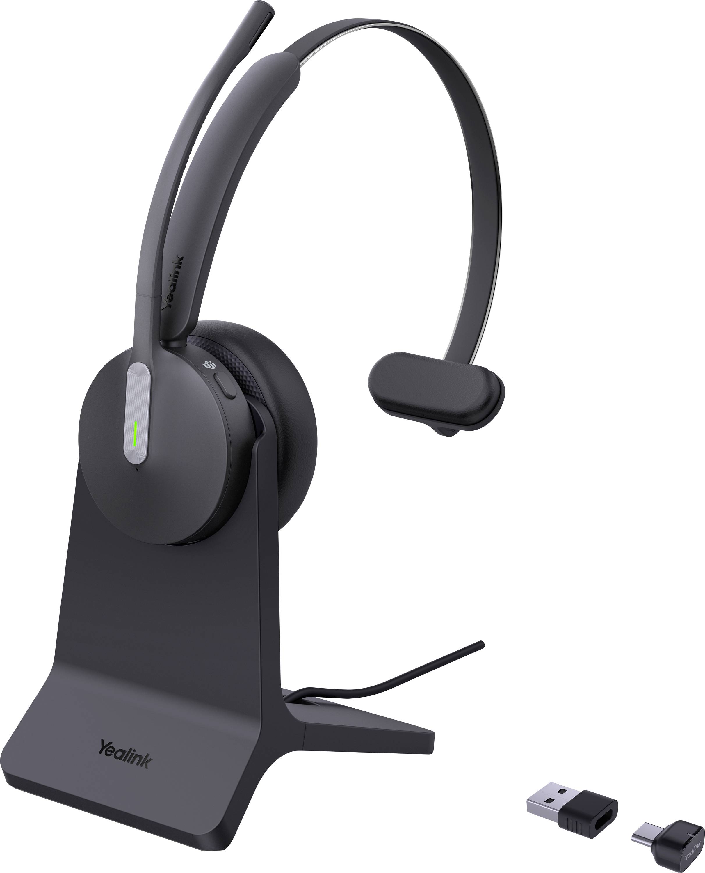 Ein schwarzes kabelloses Headset mit Mikrofon auf einem Ständer, mit USB-Dongle und Adapter in der Nähe.