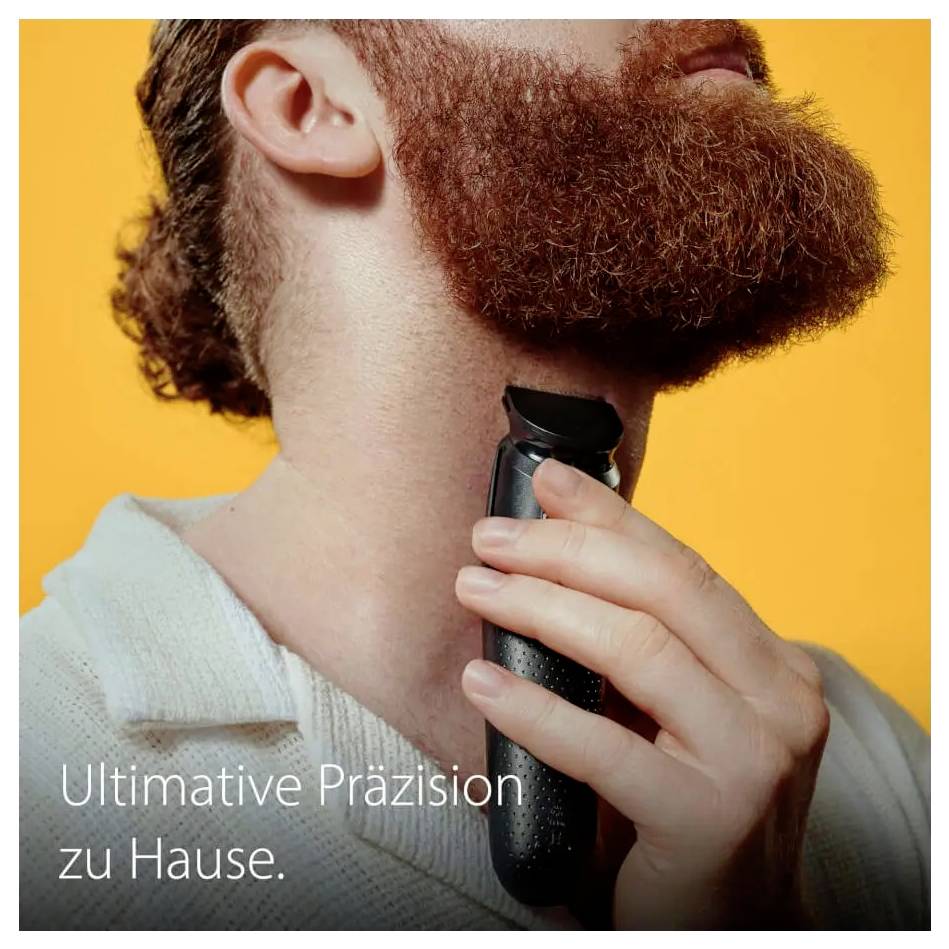 Eine Person trimmt ihren Bart mit einem elektrischen Trimmer und zeigt damit die Heimrasur. Der Text lautet „Ultimative Präzision zu Hause.