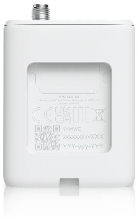 The image shows a white electronic device with a small screen or compartment, labeled with regulatory symbols and QR code on the back.