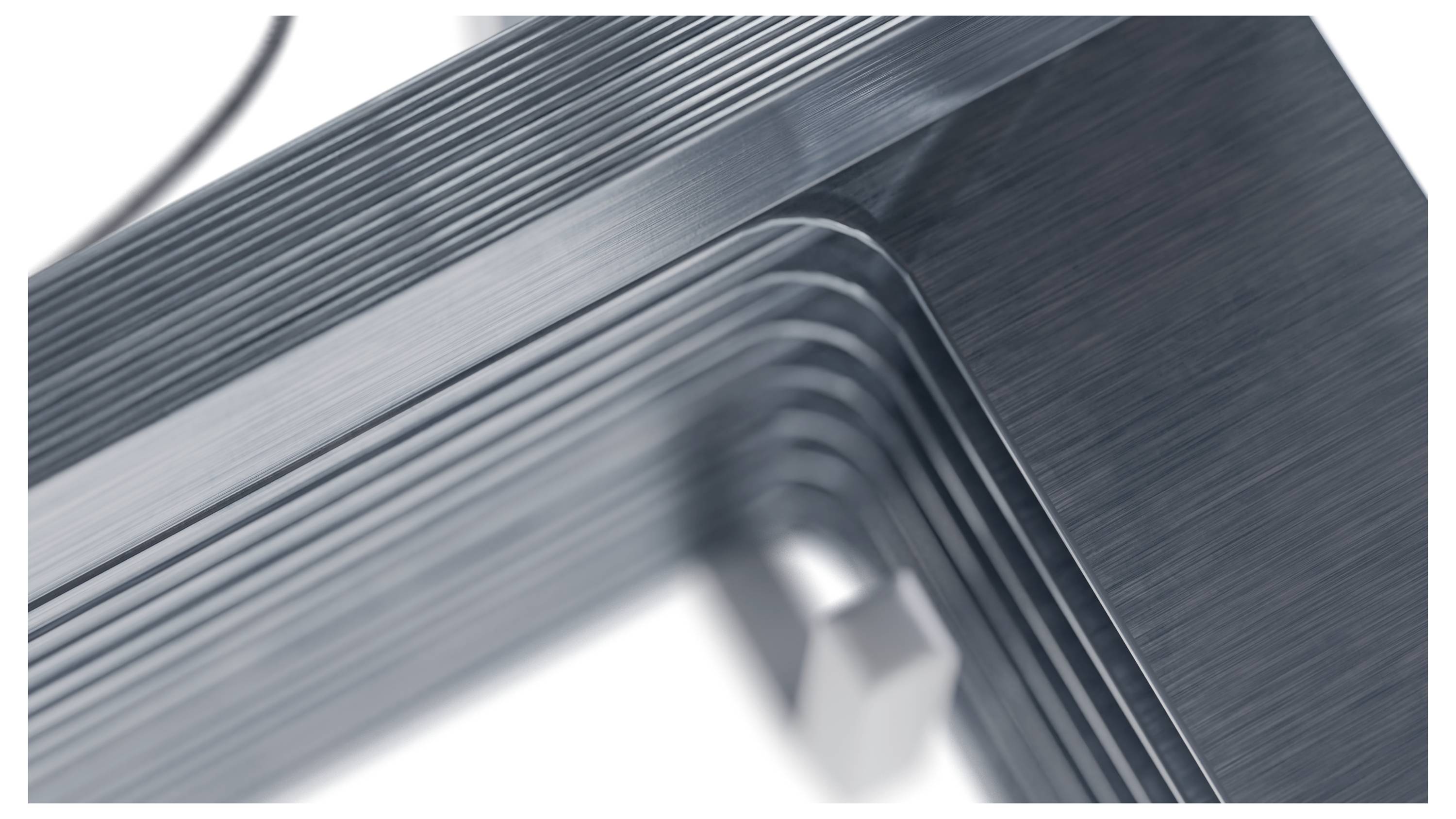 Nahaufnahme einer schlanken, modernen Metallmöbelecke mit geschichteter Gestaltung, die glatte Oberfläche und präzise Handwerkskunst zeigt.