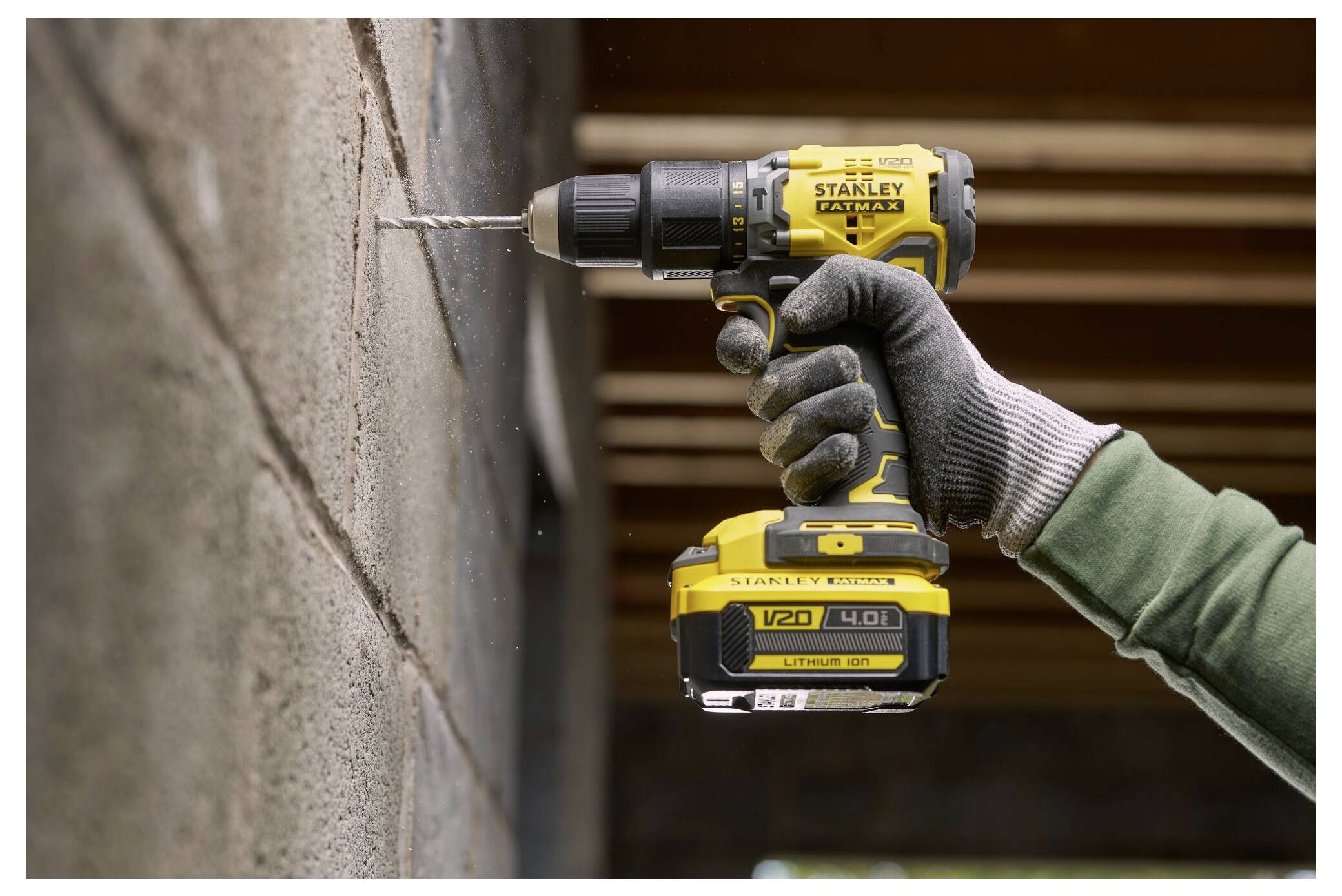 Eine Person trägt Handschuhe, während sie eine gelbe Komponente eines Gartengeräts oder einer Ausrüstung montiert oder demontiert, möglicherweise eine Trimmer-Spule.
