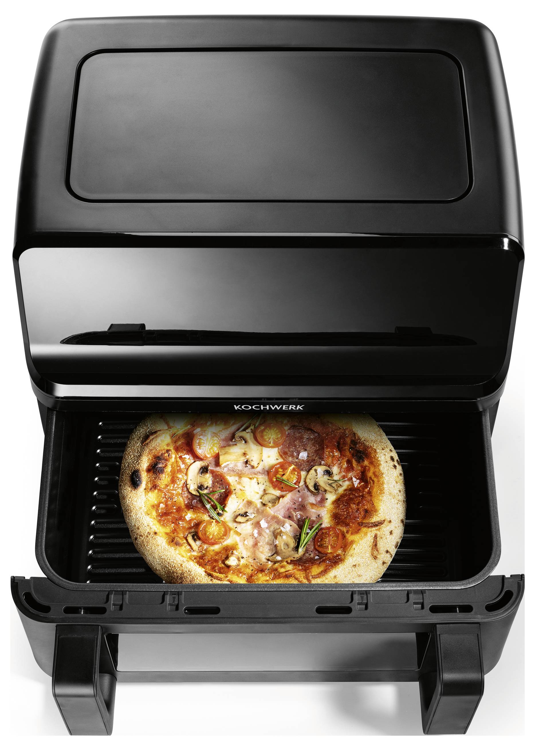 Eine Pizza mit Belägen wie Pilzen und Paprika backt in einem schwarzen, offenen Pizzaofen.