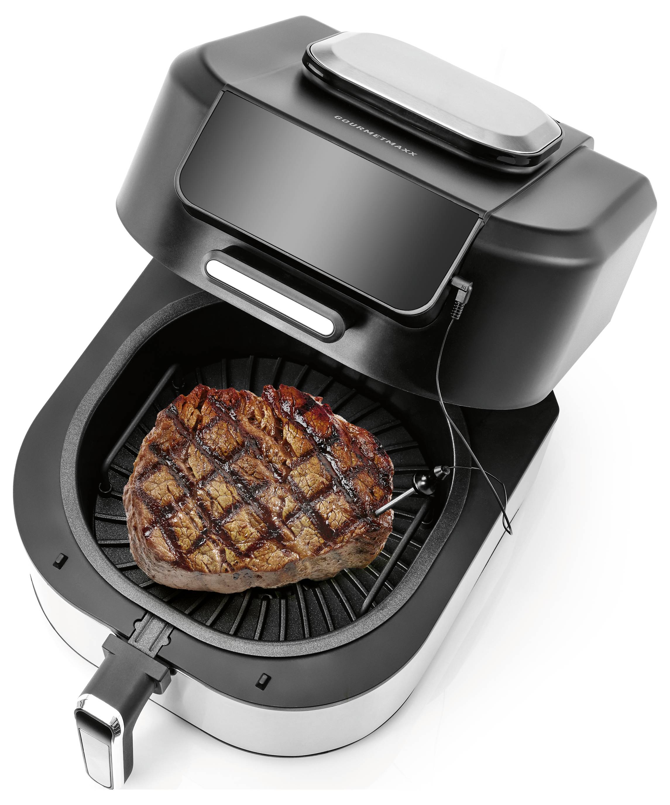 Ein Heißluftfritteur mit einem Steak im Inneren, das Grillmale zeigt, verbunden mit einer Temperaturmesssonde, was die Kochfunktionen demonstriert.