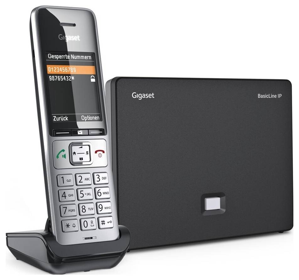 Ein schnurloses Telefon mit numerischer Tastatur auf einer Ladebasis neben einem 