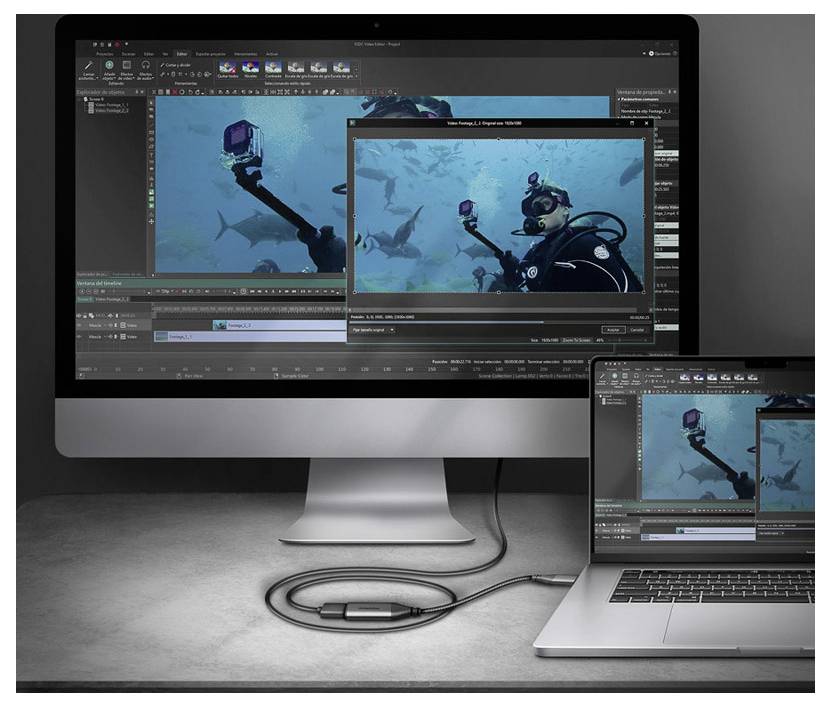 Desktop und Laptop zeigen Video-Bearbeitungssoftware mit einem geöffneten Unterwasser-Tauchclip und einem Vorschaufenster über der Zeitleiste.