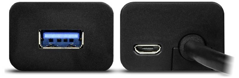 Laptop verbunden mit zwei externen Laufwerken und einem Telefon, das über einen USB-Hub auf einem Schreibtisch aufgeladen wird.