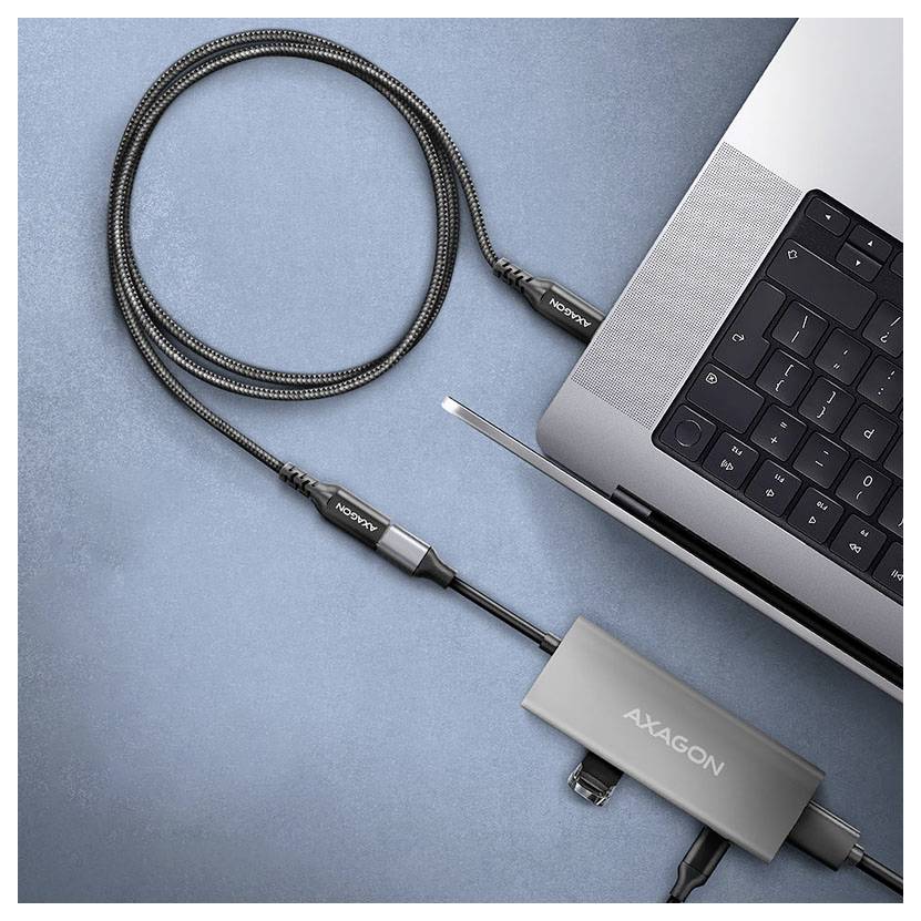 USB-C-Hub mit einem Laptop verbunden, ein geflochtenes Kabel zeigend, mit dem AXAGON-Adapter auf blauem Hintergrund.