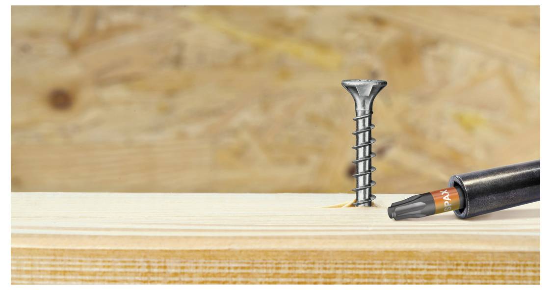 Packung mit SPAX-Antrieb STOP T25-Schraube mit Bohrspitze, zeigt eine Holzschraube und einen passenden Treiberbit in einer durchsichtigen Kunststoffbox.