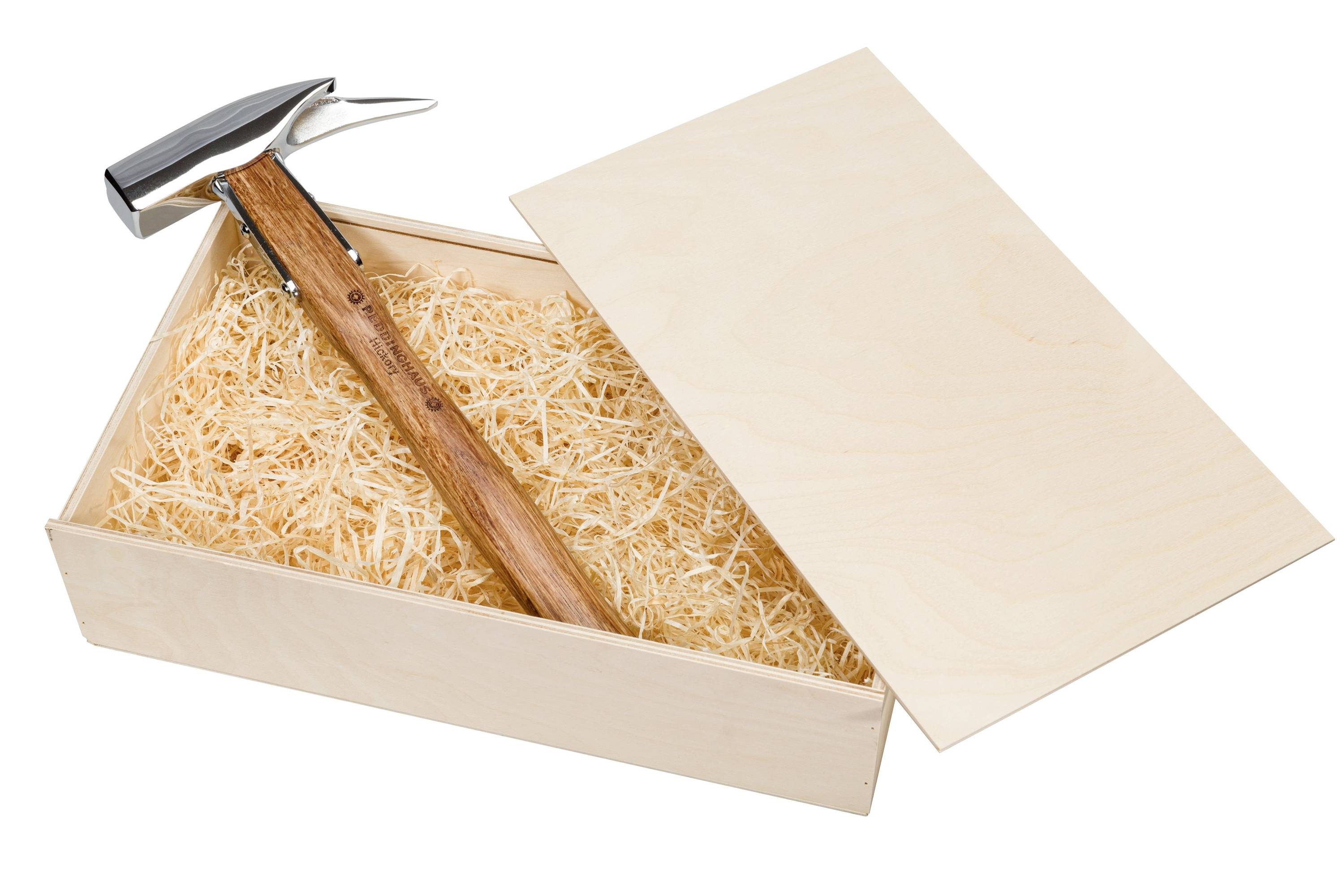 Hammer in a wooden gift box filled with packing shreds, with the lid open and leaning aside.